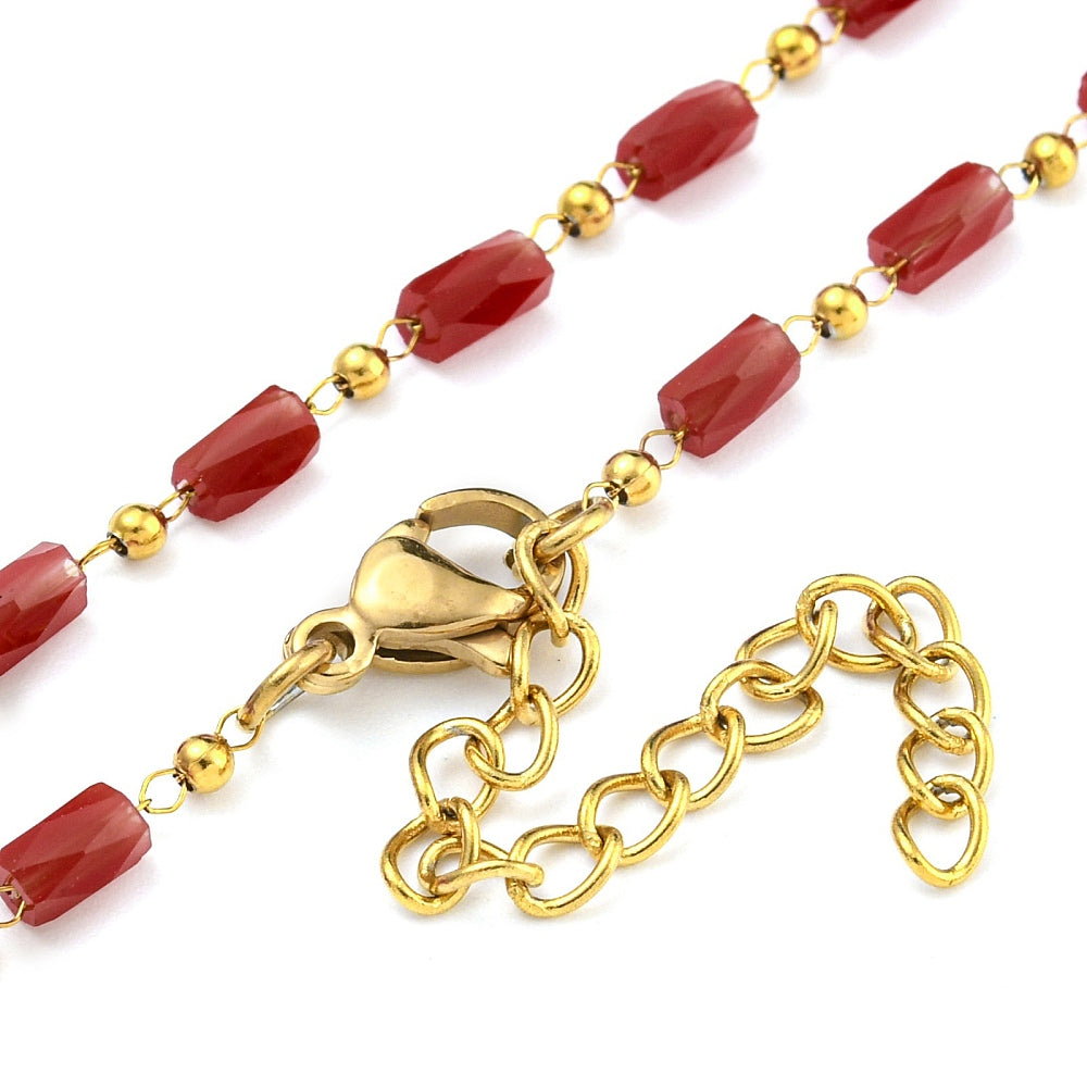zoomed in sections of red glass column link chain necklace with  golden lobster claw clasp and extender chain on white background. 