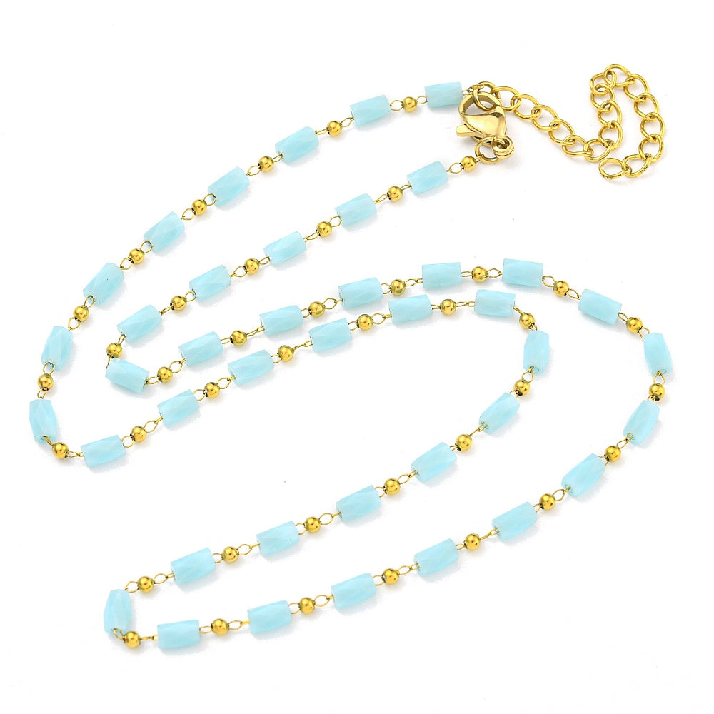 light blue glass column link chain necklace with golden lobster claw clasp and extender chain on white background. 