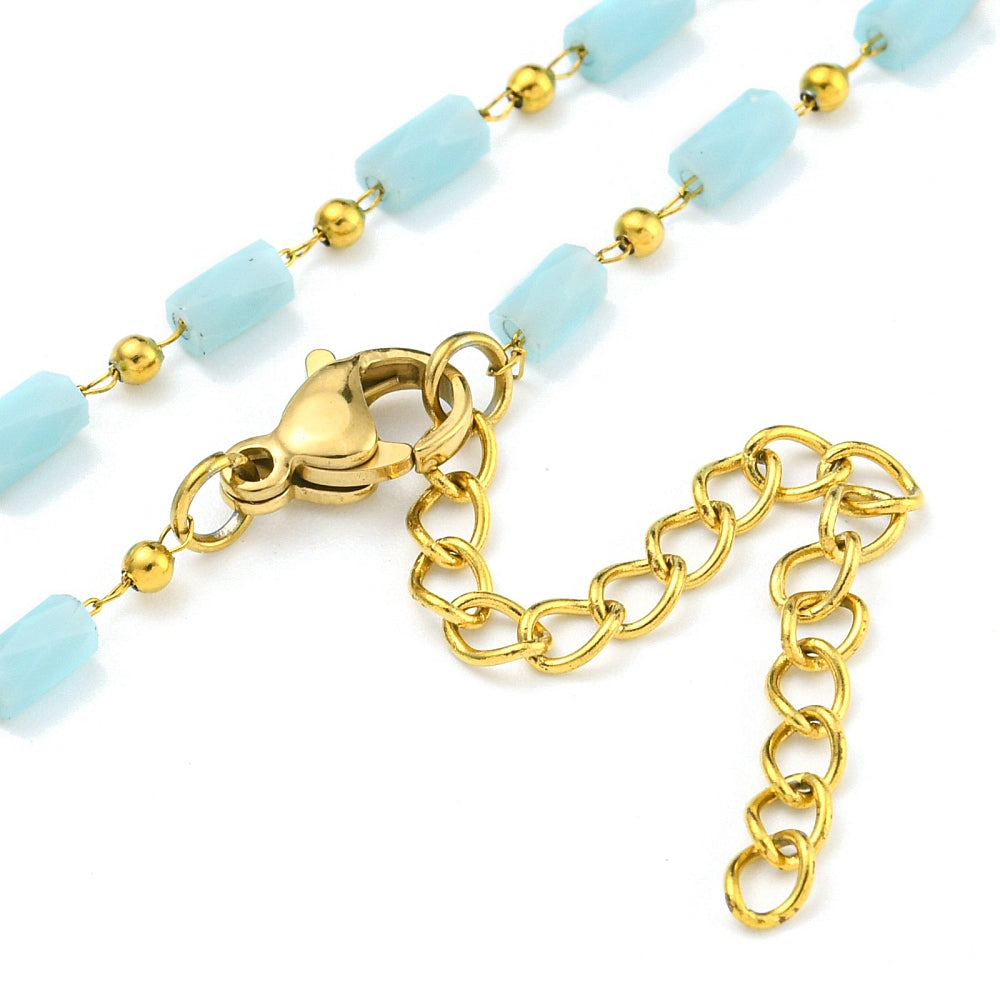 zoomed in sections of light blue glass column link chain necklace with golden lobster claw clasp and extender chain on white background. 