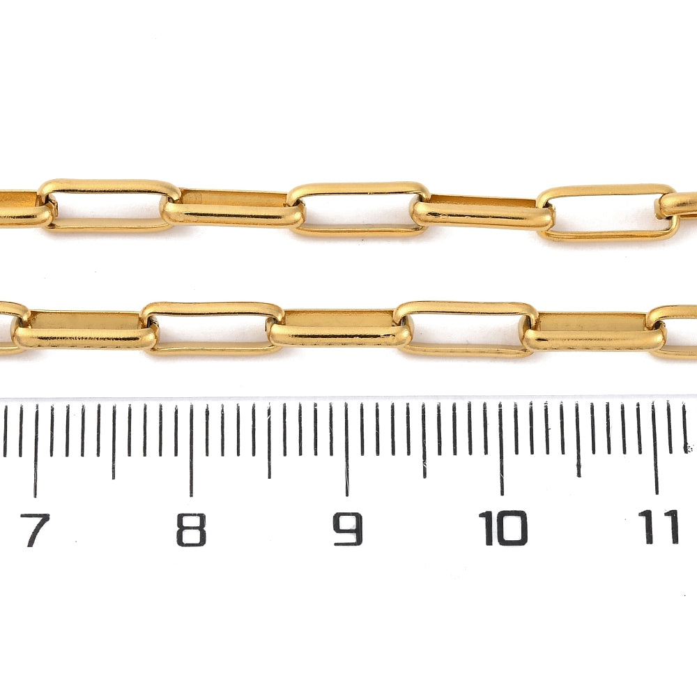 golden square paperclip chains over ruler with white background. 