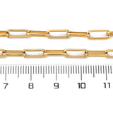 golden square paperclip chains over ruler with white background. 