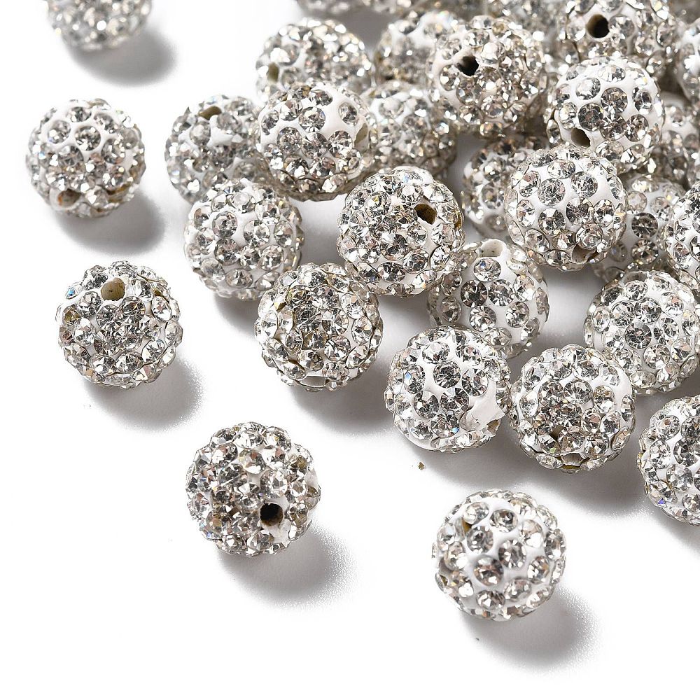 loose pave clear rhinestone clay beads over white background. 
