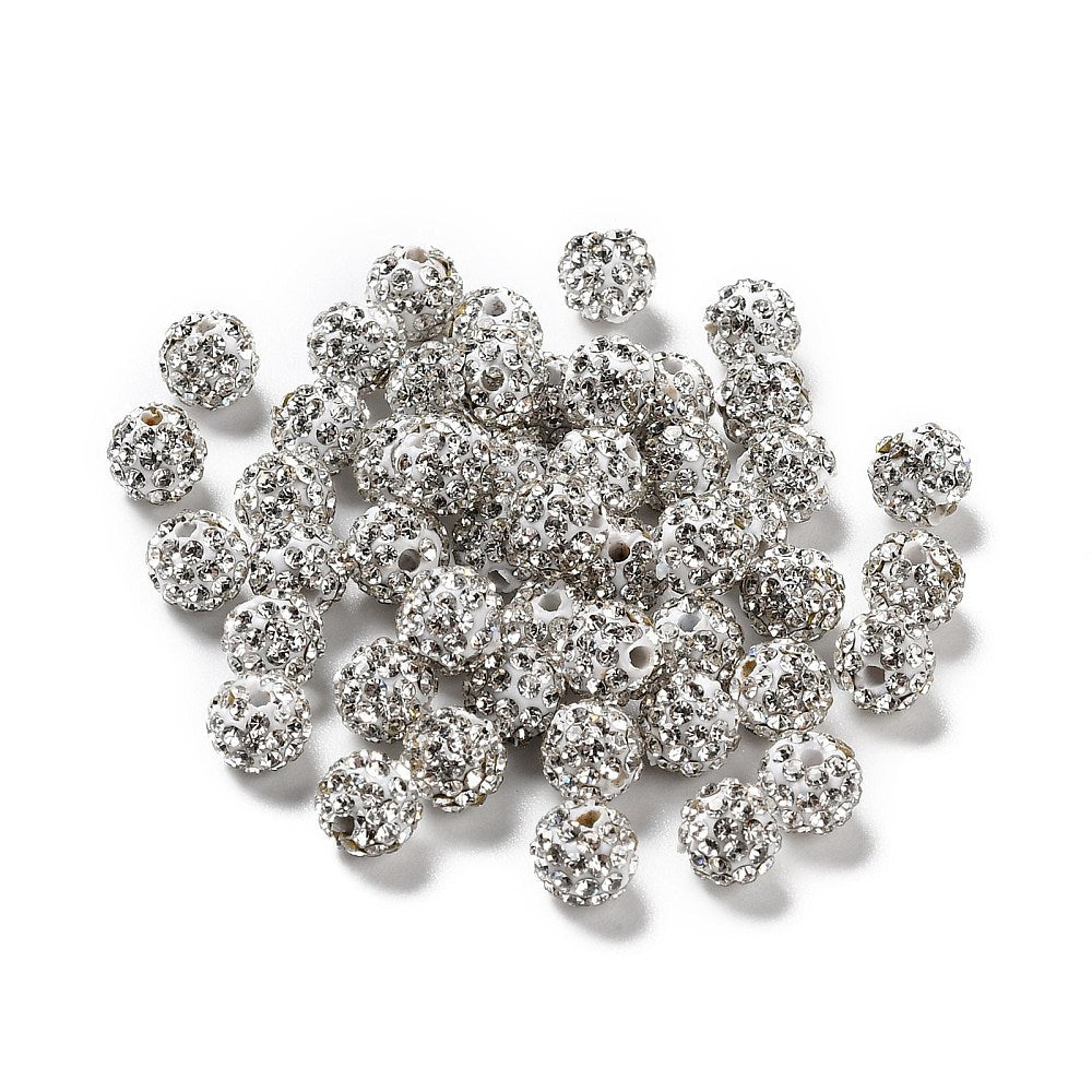 loose pave clear rhinestone clay beads over white background. 