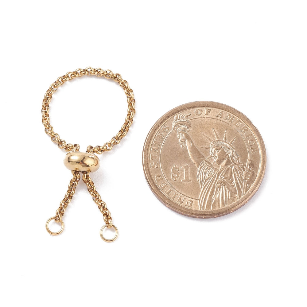 golden adjustable fidget ring with Rolo chain and slider bead and two jump rings next to dollar coin over white background. 