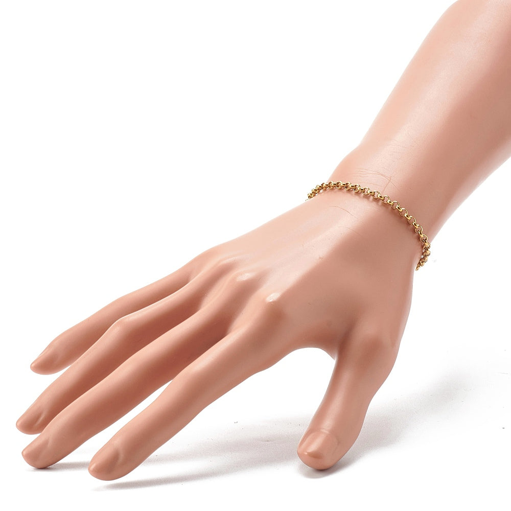  golden rolo chain displayed on mannequin hand over white background. 