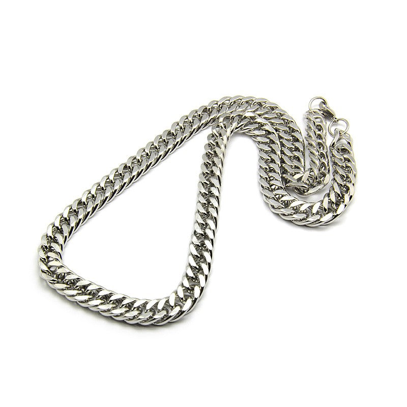 silver tone large Cuban link chain necklace with lobster claw clasp on white background. 
