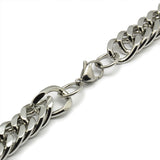 zoomed in section of silver tone lobster claw clasp on large Cuban link chain against a white background. 