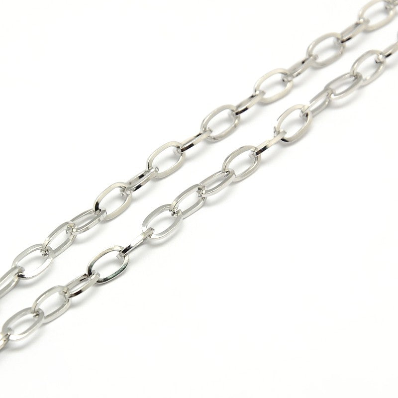 silver tone oval cable link chains on white background. 