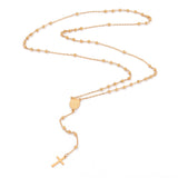 golden rosary bead necklace with oval medal connector and cross pendant over white background. 