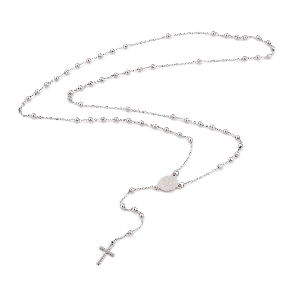 silver tone rosary bead necklace with oval medal connector and cross pendant over white background. 