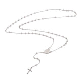 silver tone rosary bead necklace with oval medal connector and cross pendant over white background. 