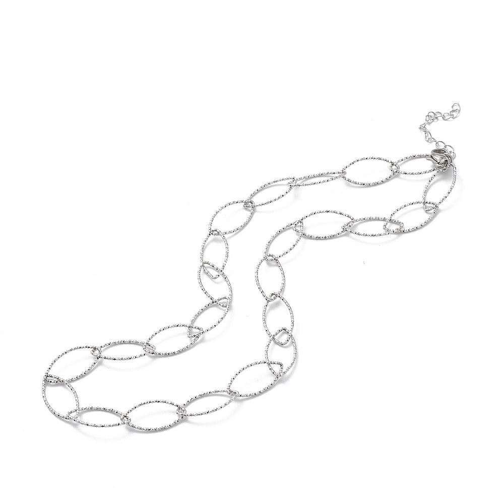 silver tone textured horse eye link necklace with lobster claw clasp and extender chain on white background. 