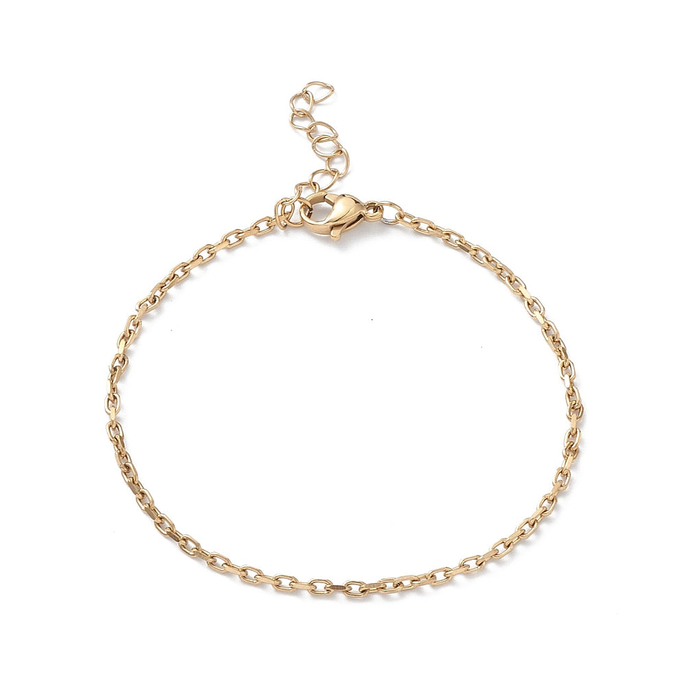 golden cable chain bracelet with lobster claw clasp and extender chain over white surface. 