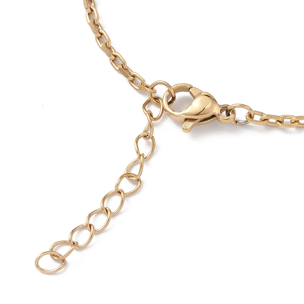 zoomed in section of golden cable chain bracelet with lobster claw clasp and extender chain over white surface. 