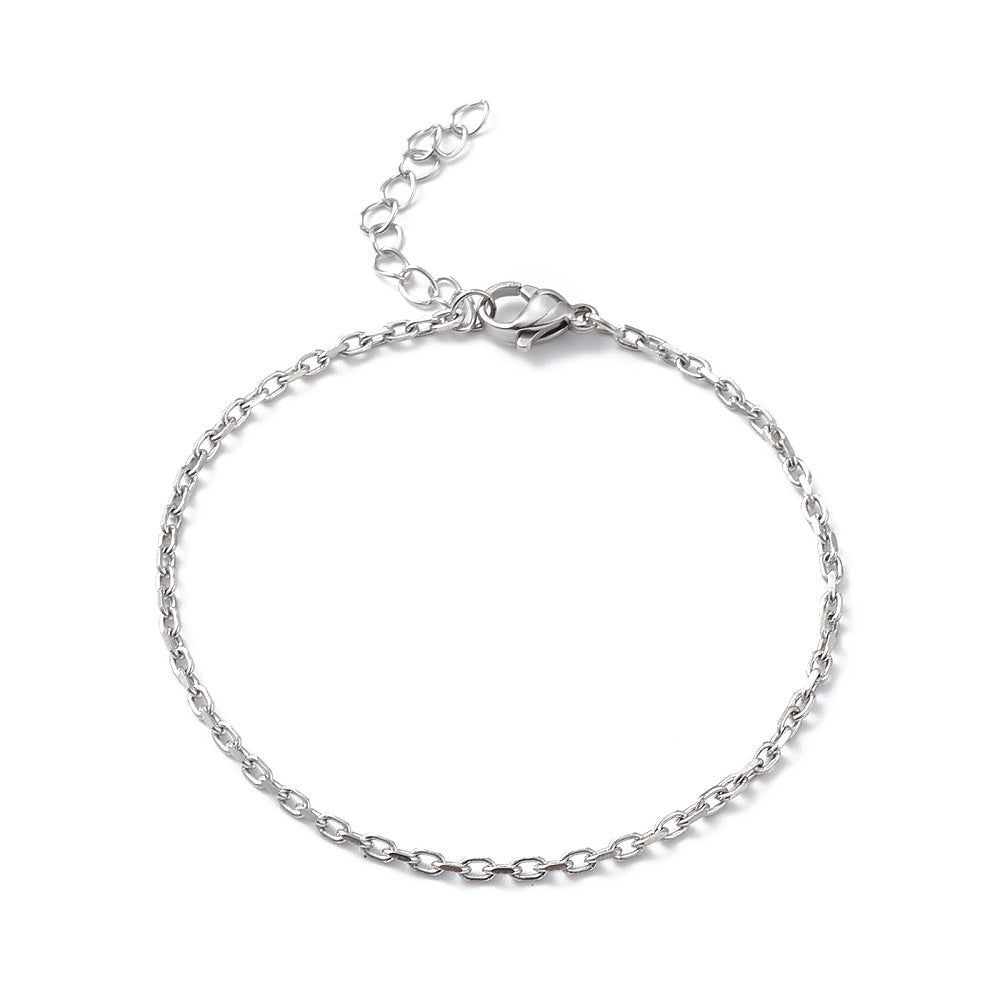 silver tone cable chain bracelet with lobster claw clasp and extender chain over white surface. 