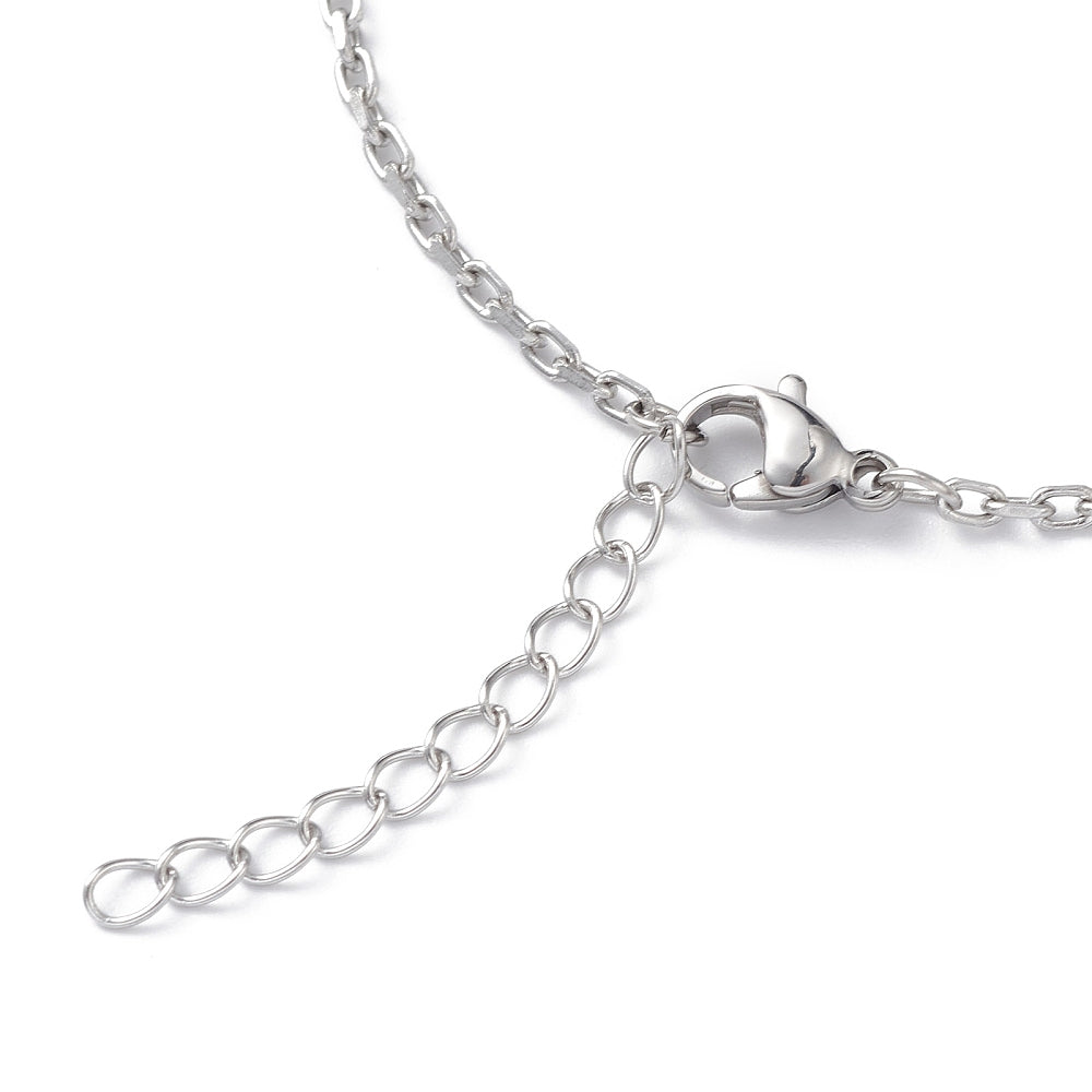 zoomed in section of silver tone cable chain bracelet with lobster claw clasp and extender chain over white surface. 
