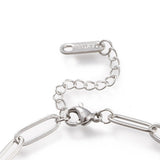 zoomed in section of silver tone lobster claw clasp and extender chain on paperclip chain over white background. 