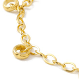 zoomed in section of golden add-a-charm bracelet with evenly spaced, dangling, soldered jump rings on white background. 