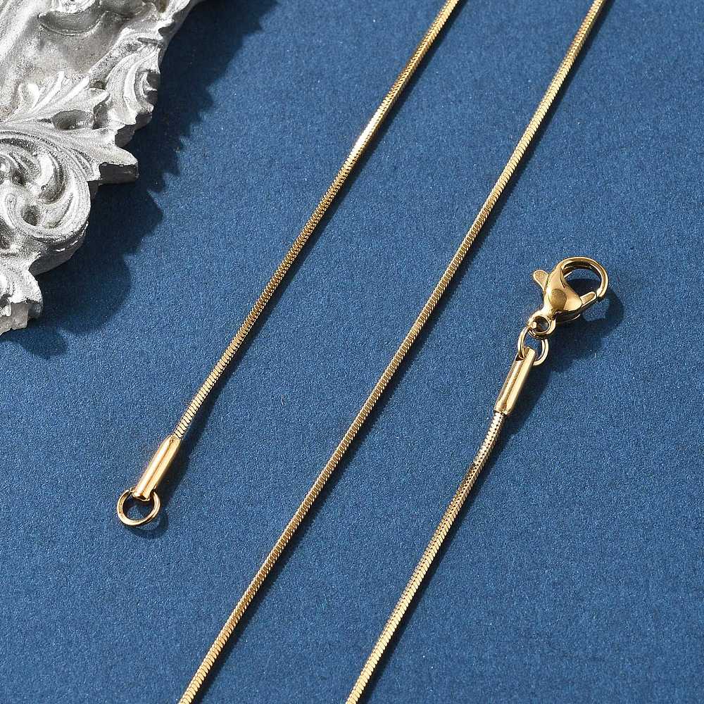 golden square snake chain with lobster claw clasp on blue felt background. 