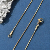 golden square snake chain with lobster claw clasp on blue felt background. 