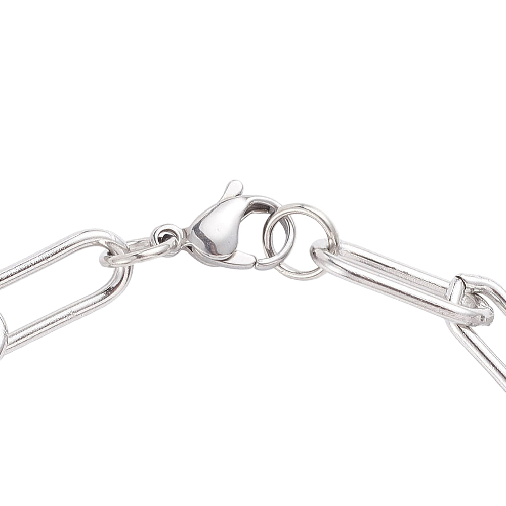 zoomed in silver tone lobster claw clasp on rounded paperclip chain on white background. 