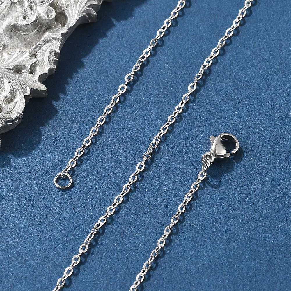 silver tone fine flat cable chain necklace with lobster claw clasp on a blue felt background. 