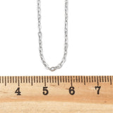 silver tone fine flat cable chain necklace displayed above a wooden ruler on a white background. 