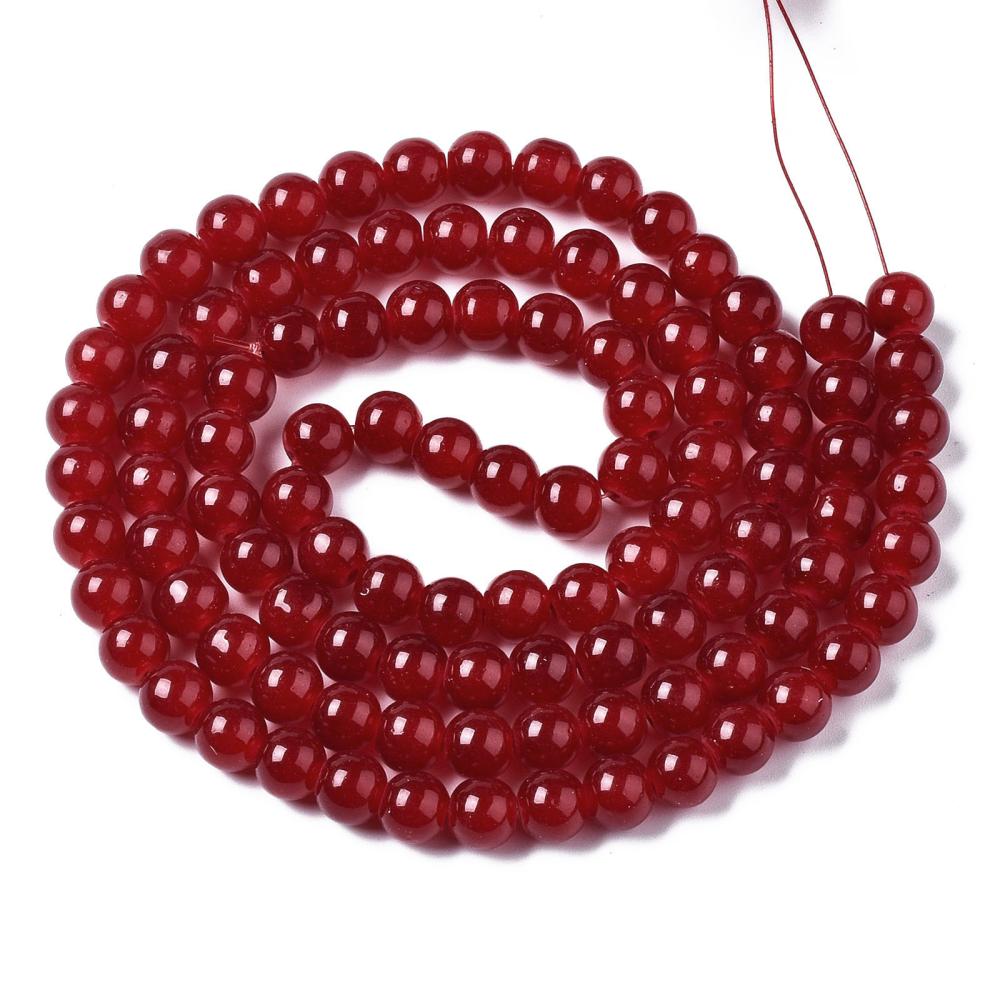 red round glass bead strand in swirl design over white background.