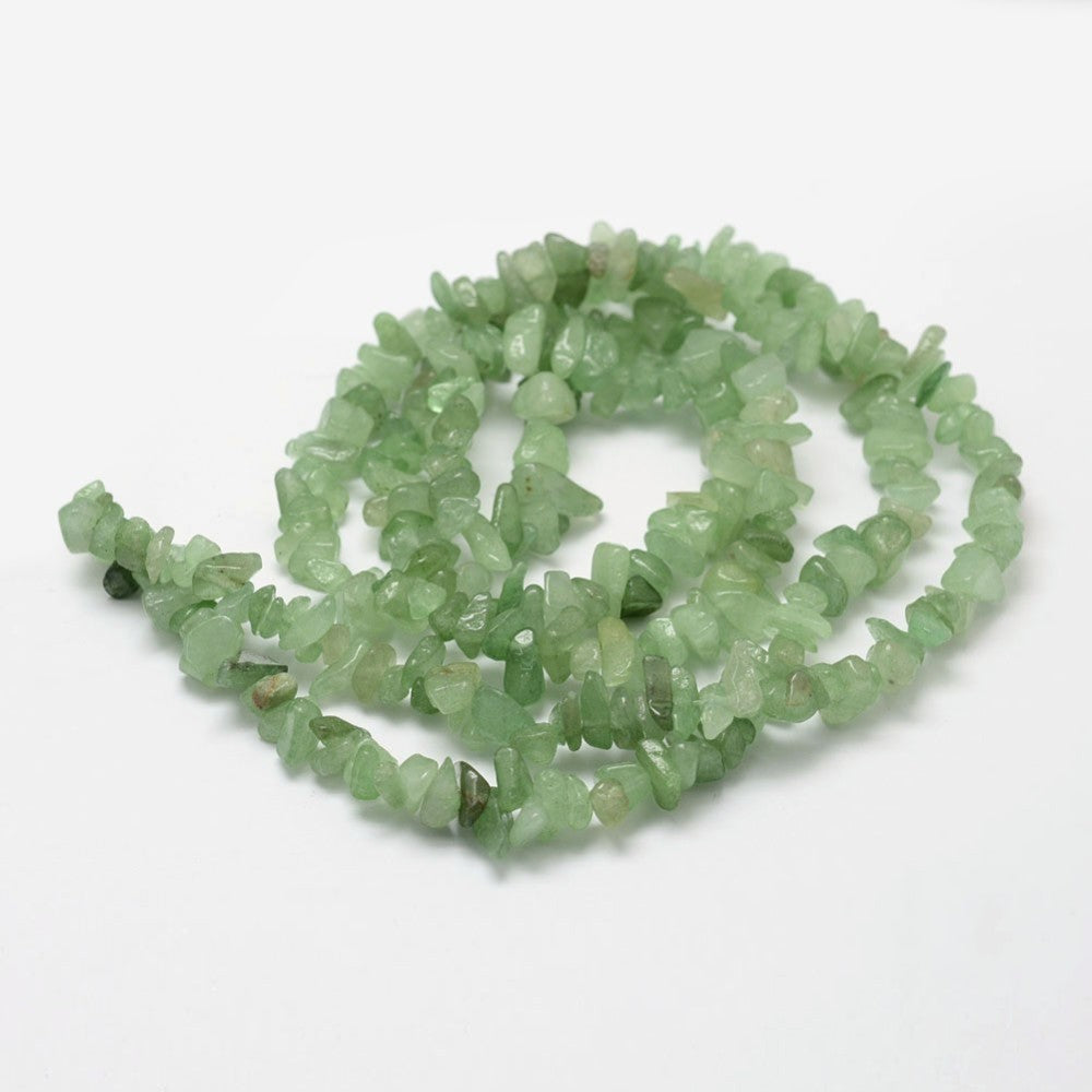 green aventurine chip bead strand in swirl design over white background. 