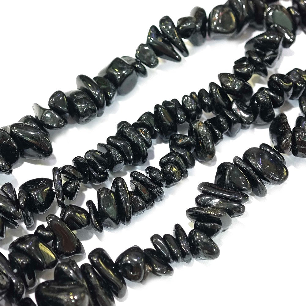 four black tourmaline stone chip strands over white background. 