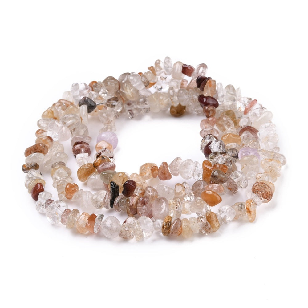 multi-color rutilated quartz chip bead strand in swirl design over white surface. 