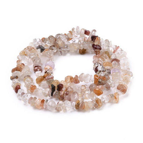 multi-color rutilated quartz chip bead strand in swirl design over white surface. 
