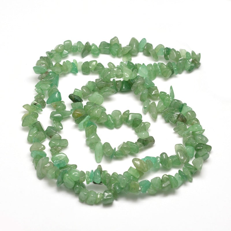 green aventurine chip bead strand in swirl design over white background. 