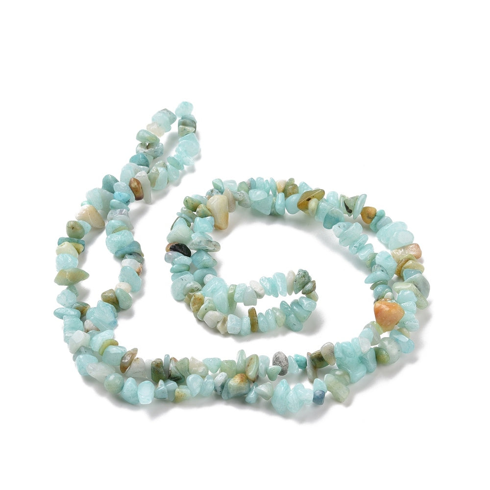 natural flower amazonite chip bead strand in a swirl design over white surface. 