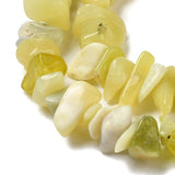zoomed in sections of lemon jade chip bead strands over white surface. 