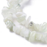 zoomed in sections of new jade chip bead strands over white surface. 