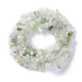 new jade chip bead strand in swirl design over white surface. 