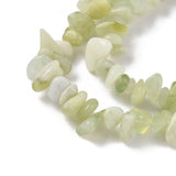zoomed in sections of new jade chip bead strands over white surface. 