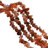 four red agate chip bead strands over white surface.