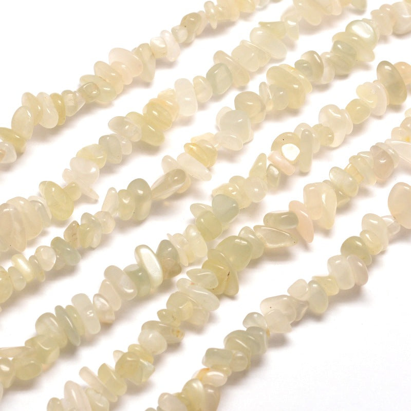 six strands of white moonstone chip beads over white background. 