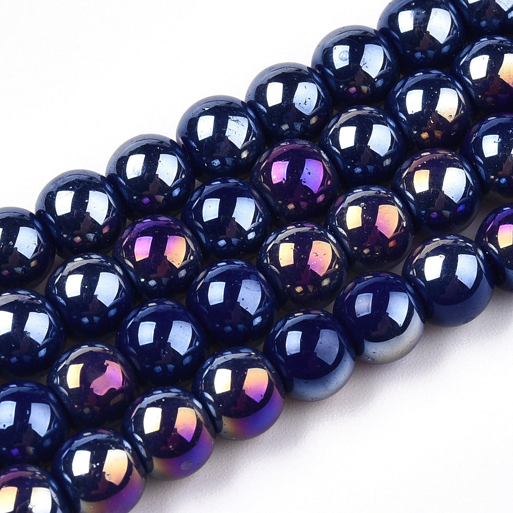 zoomed in sections of four iridescent blue glass bead strands over white surface.  