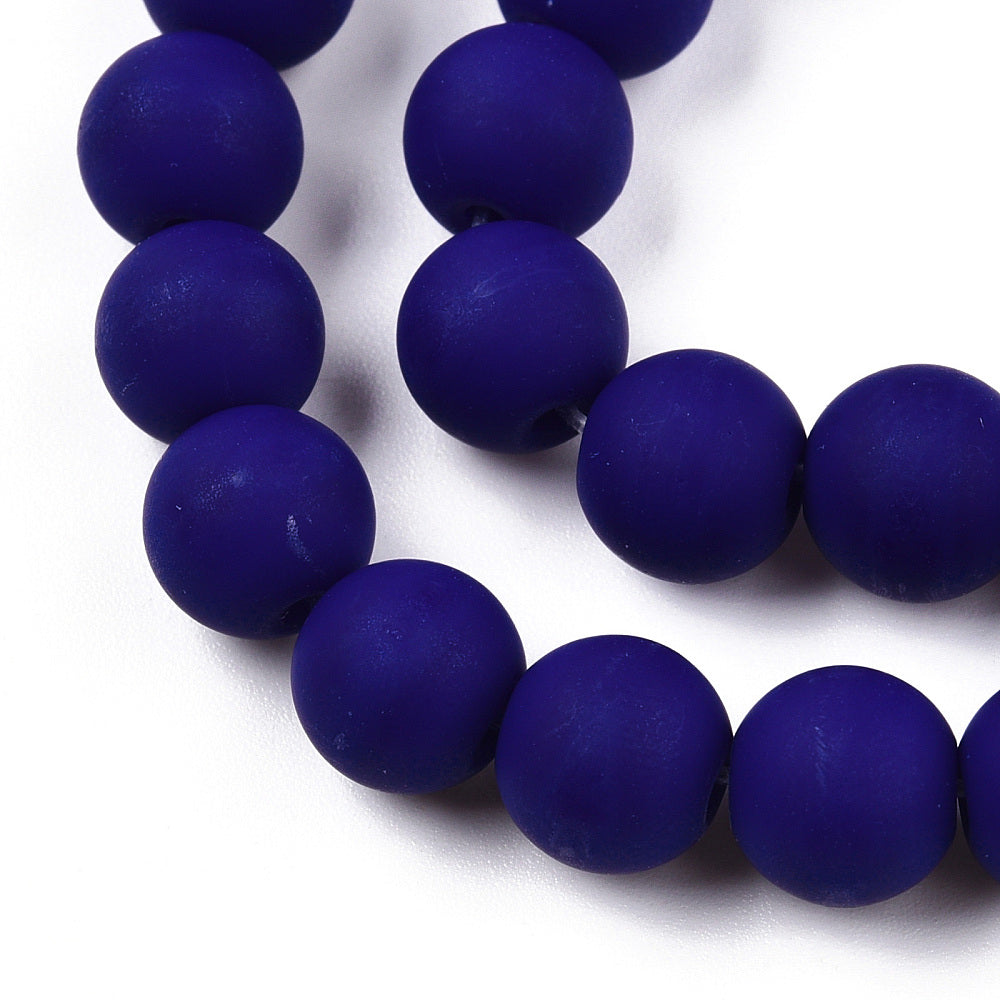 zoomed in sections of frosted opaque navy blue round bead strands over white background. 