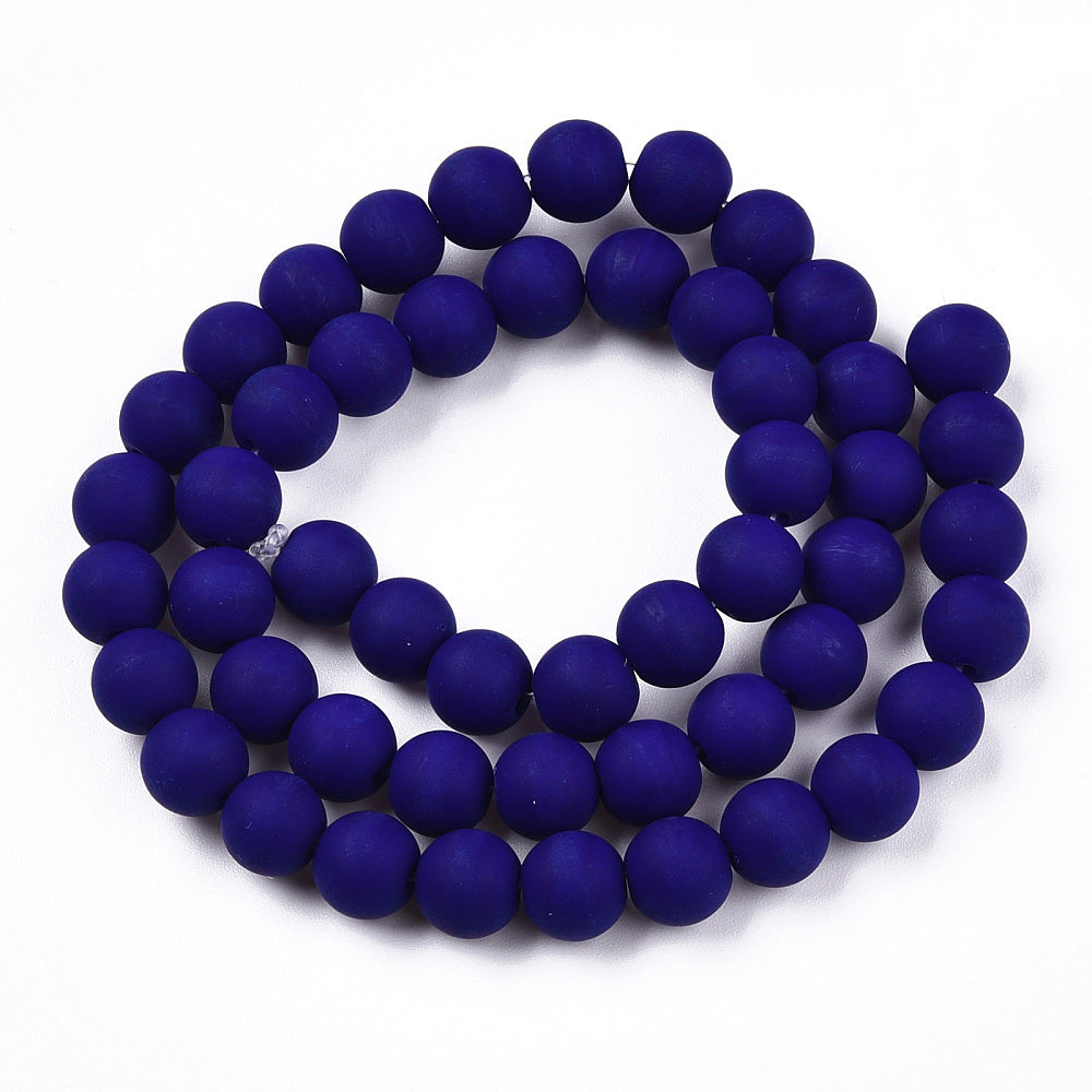 frosted opaque navy blue round bead strand in swirl design over white background. 
