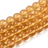 champagne colored round glass bead strands over white surface. 