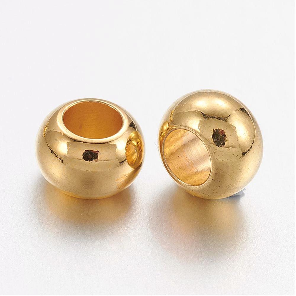 two golden smooth rondelle spacer beads over white background. 