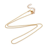 golden ball chain with lobster claw clasp and extender chain over white background. 