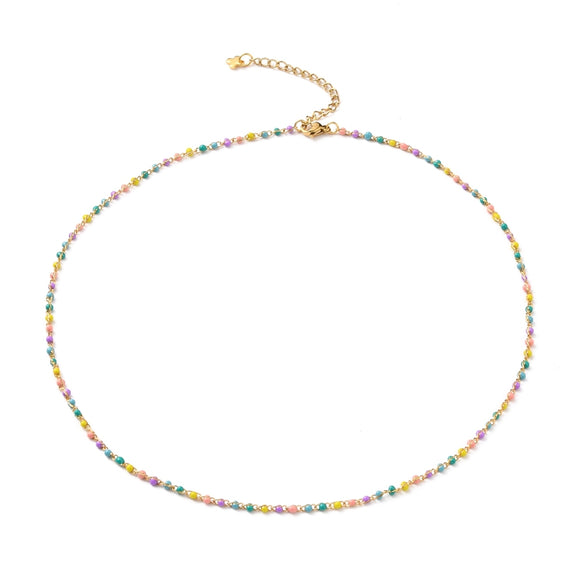 golden multi-color enamel twisted chain necklace with lobster claw clasp extender chain and cross charm over white background. 
