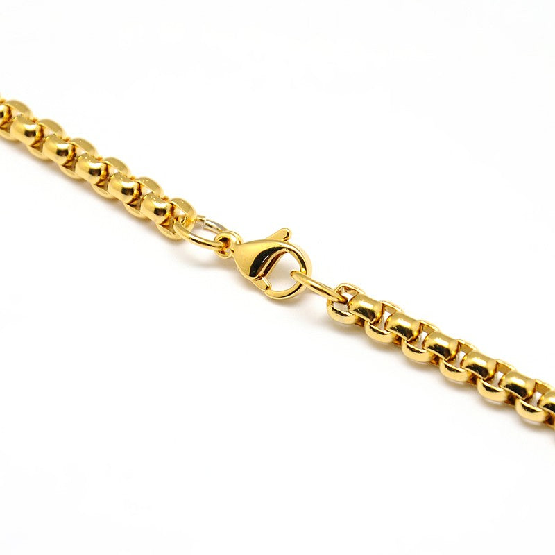 zoomed in section of golden heavy Venetian box chain necklace with lobster claw clasp over white background. 