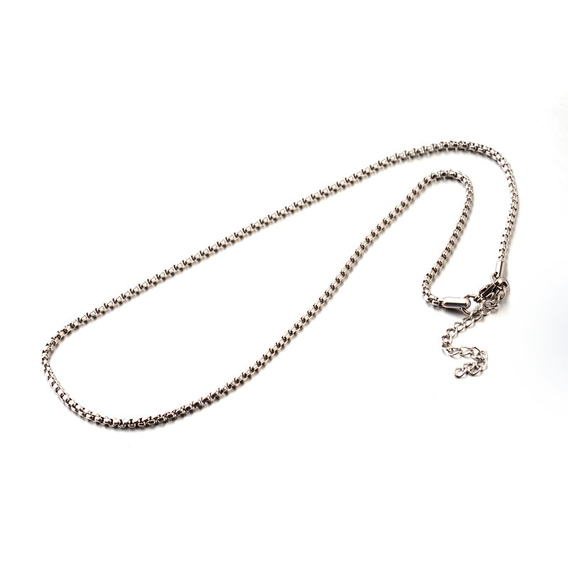 silver tone Venetian box chain with lobster claw clasp and extender chain over white background. 