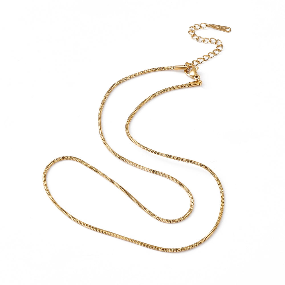 golden snake chain necklace with lobster claw clasp and extender chain on white background. 